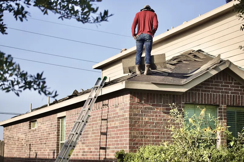Professional roofer working on a residential roof in Robertson Ranch